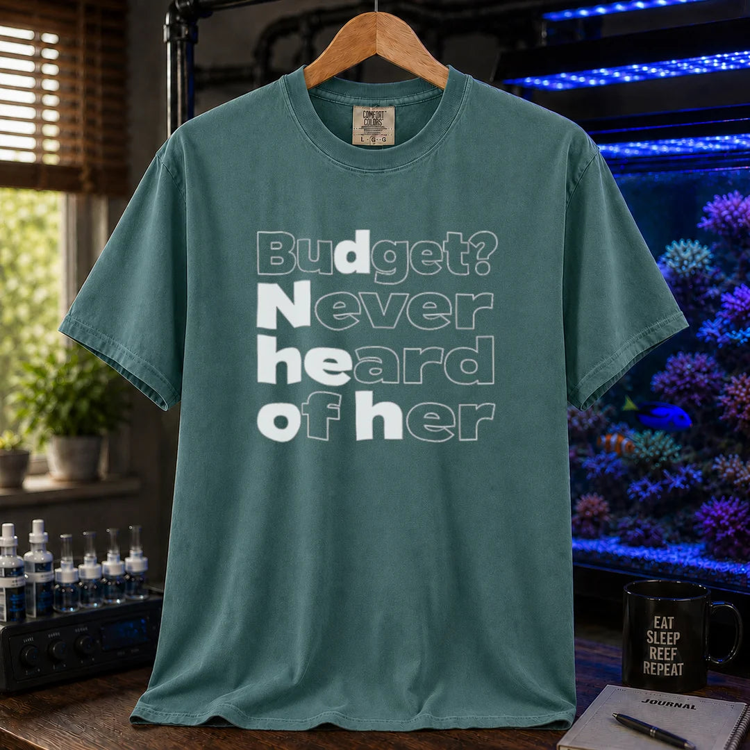 Saltwater aquarium graphic t-shirt featuring bold minimalist white typography reading Budget? Never Heard Of Her with outlined and solid letters, green crew neck tee