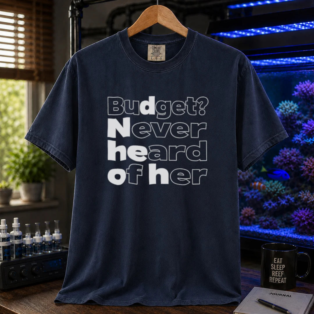 Saltwater aquarium graphic t-shirt featuring bold minimalist white typography reading Budget? Never Heard Of Her with outlined and solid letters, navy crew neck tee