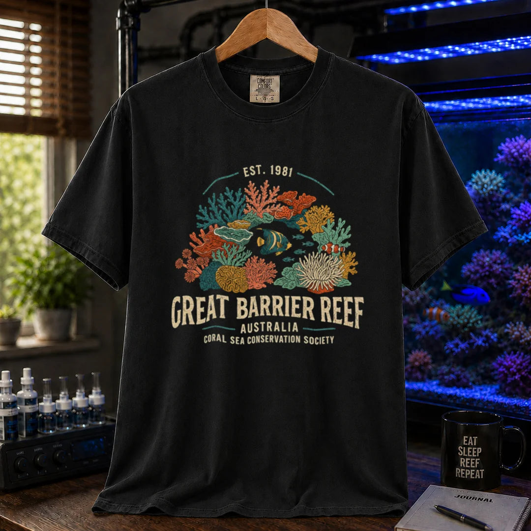 Saltwater aquarium graphic t-shirt featuring detailed vintage illustration of coral reefs and tropical fish with text reading Great Barrier Reef Australia Coral Sea Conservation Society Est. 1981, black crew neck tee