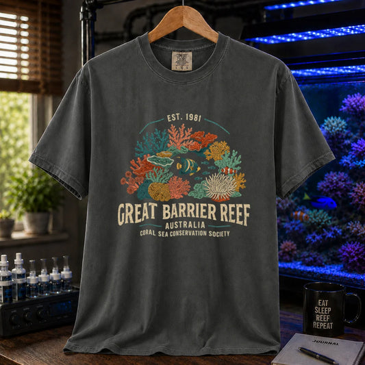 Saltwater aquarium graphic t-shirt featuring detailed vintage illustration of coral reefs and tropical fish with text reading Great Barrier Reef Australia Coral Sea Conservation Society Est. 1981, dark grey crew neck tee