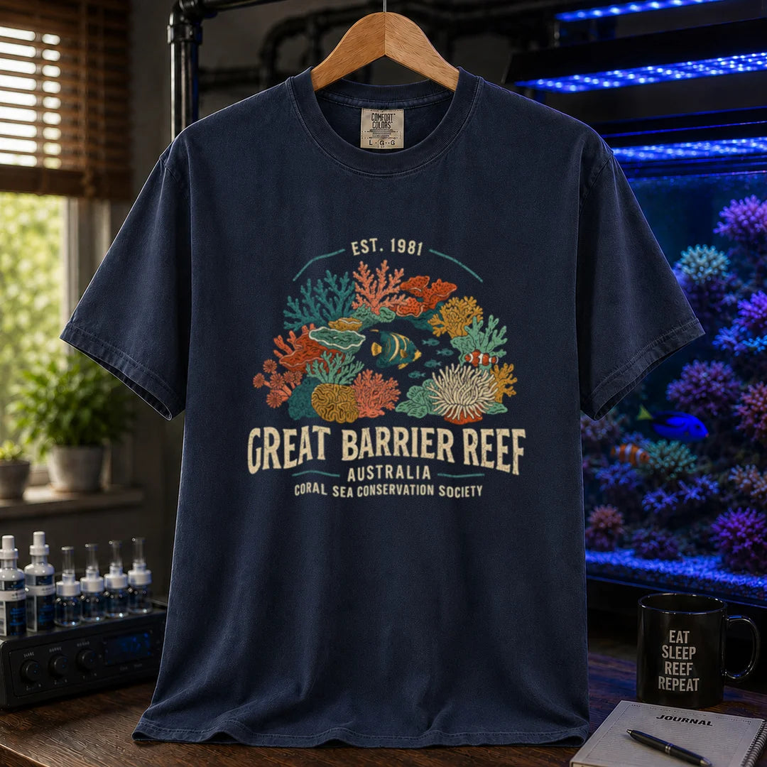 Saltwater aquarium graphic t-shirt featuring detailed vintage illustration of coral reefs and tropical fish with text reading Great Barrier Reef Australia Coral Sea Conservation Society Est. 1981, navy crew neck tee