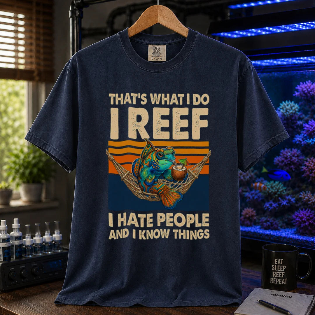 Saltwater aquarium graphic t-shirt featuring a mandarin goby in a hammock with a drink against a retro sunset and text reading That's What I Do I Reef I Hate People And I Know Things, navy crew neck tee