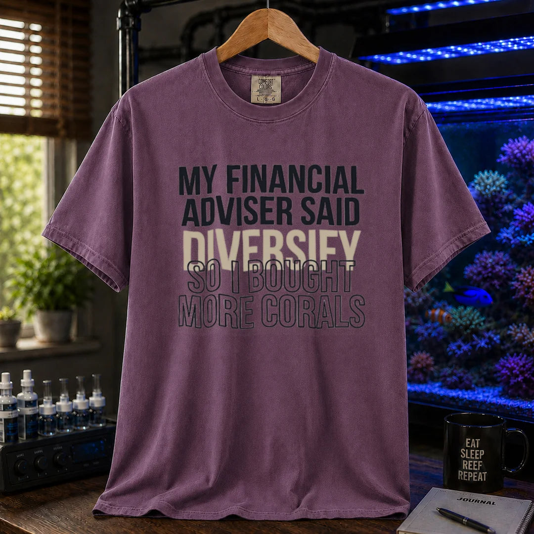 Saltwater aquarium graphic t-shirt featuring bold text reading My Financial Adviser Said Diversify So I Bought More Corals, purple crew neck te