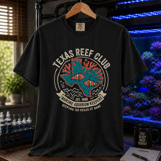 Saltwater aquarium graphic t-shirt featuring a vintage emblem with coral shaped like Texas, clownfish, and text reading Texas Reef Club Marine Aquarium Keepers Est. 1998, black crew neck tee