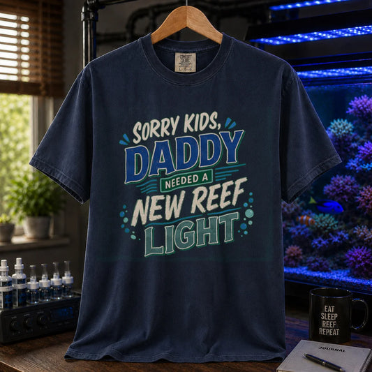 Saltwater aquarium graphic t-shirt featuring multi-color distressed typography reading Sorry Kids, Daddy Needed A New Reef Light with bubble accents, navy crew neck tee