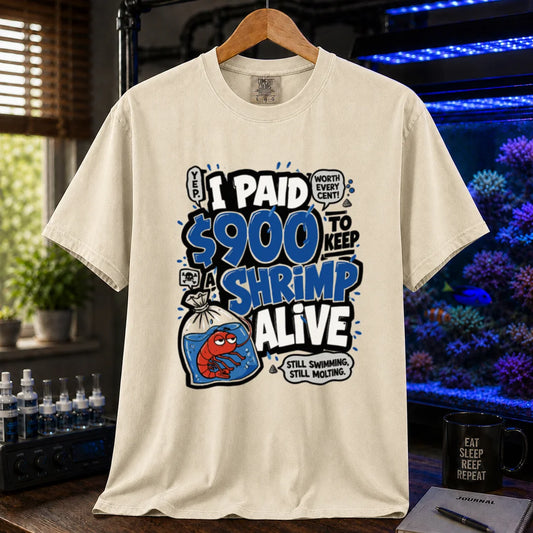 Saltwater aquarium graphic t-shirt featuring comic typography and a cartoon shrimp in a bag with text reading I Paid $900 To Keep A Shrimp Alive, cream, beige, ivory crew neck tee