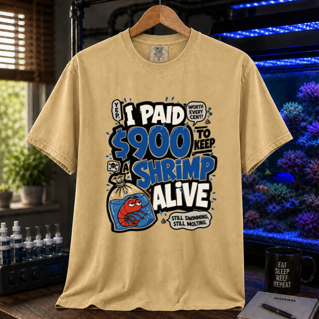 Saltwater aquarium graphic t-shirt featuring comic typography and a cartoon shrimp in a bag with text reading I Paid $900 To Keep A Shrimp Alive, mustard crew neck tee