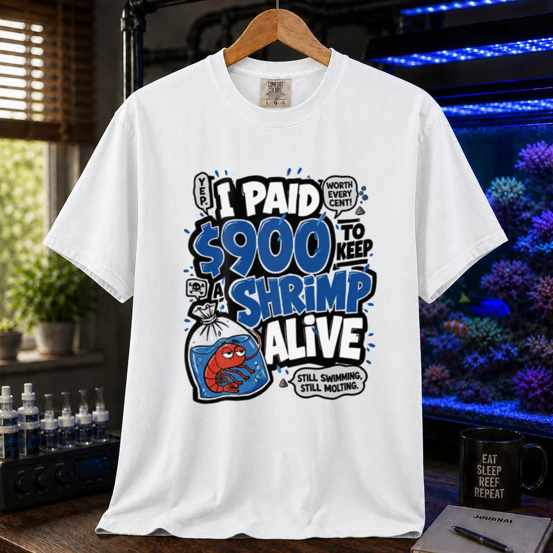 Saltwater aquarium graphic t-shirt featuring comic typography and a cartoon shrimp in a bag with text reading I Paid $900 To Keep A Shrimp Alive, white crew neck tee