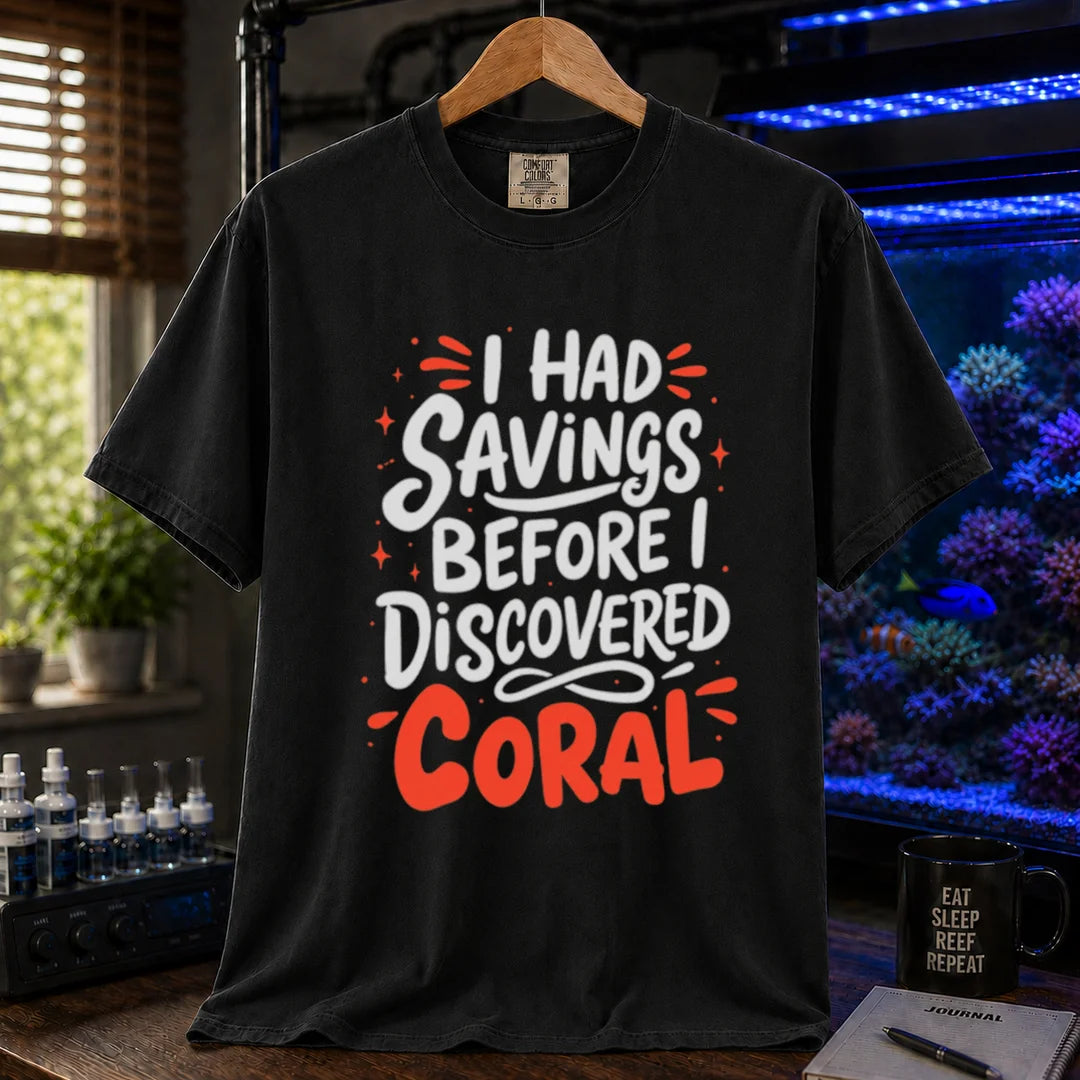 Saltwater aquarium graphic t-shirt featuring playful white and coral typography with sparkle accents reading I Had Savings Before I Discovered Coral, black crew neck tee