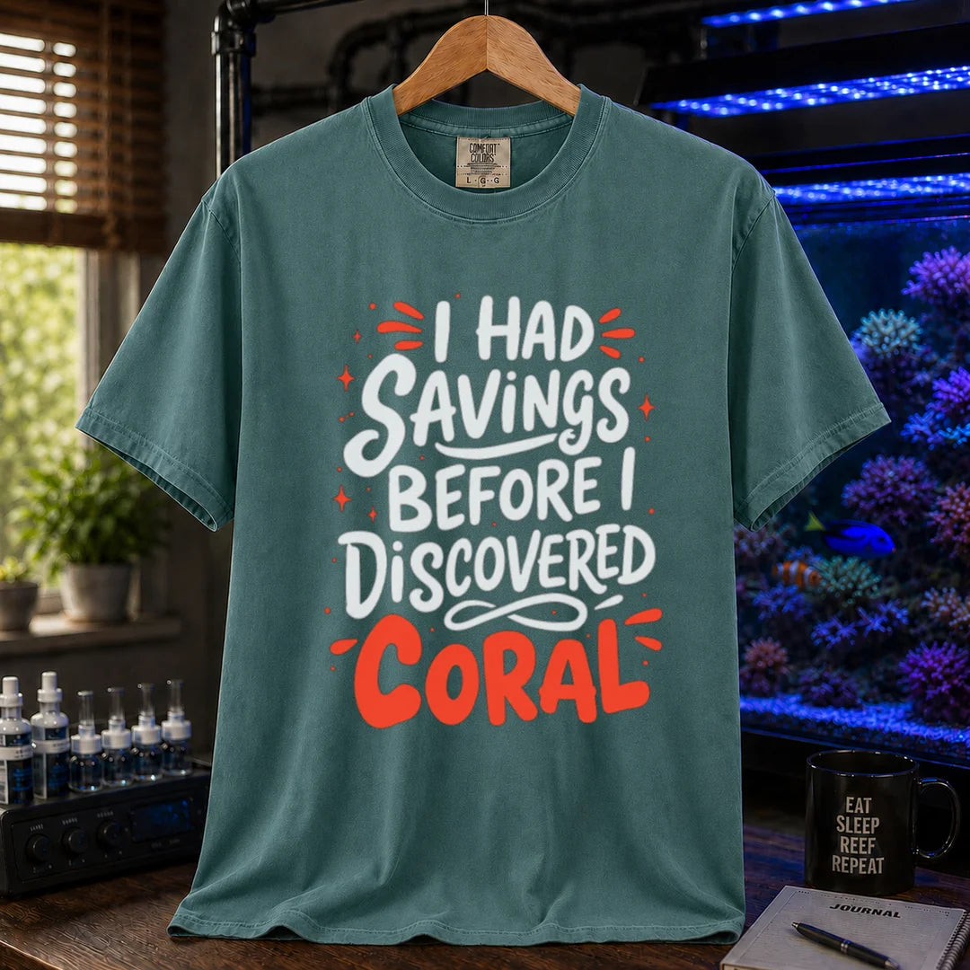 Saltwater aquarium graphic t-shirt featuring playful white and coral typography with sparkle accents reading I Had Savings Before I Discovered Coral, green crew neck tee