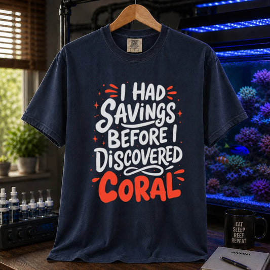 Saltwater aquarium graphic t-shirt featuring playful white and coral typography with sparkle accents reading I Had Savings Before I Discovered Coral, navy crew neck tee