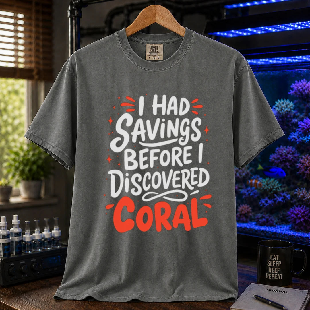 Saltwater aquarium graphic t-shirt featuring playful white and coral typography with sparkle accents reading I Had Savings Before I Discovered Coral, dark grey crew neck tee