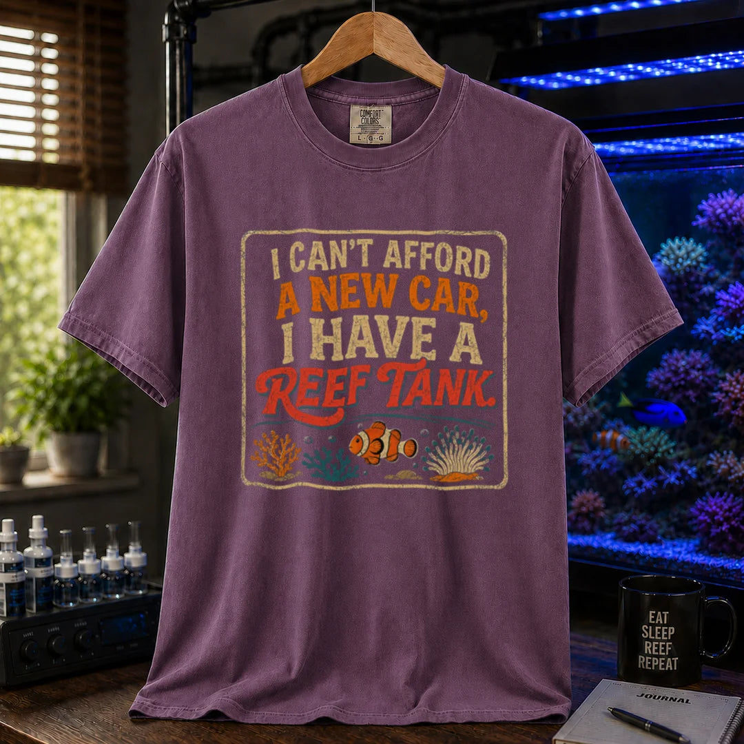 Saltwater aquarium graphic t-shirt featuring a vintage square design with text reading I Can't Afford a New Car, I Have a Reef Tank and a clownfish illustration, purple crew neck tee