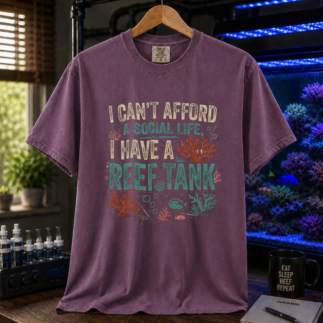 Saltwater aquarium graphic t-shirt featuring a vintage square design with text reading I Can't Afford a Social Life, I Have a Reef Tank and coral illustrations, purple crew neck tee