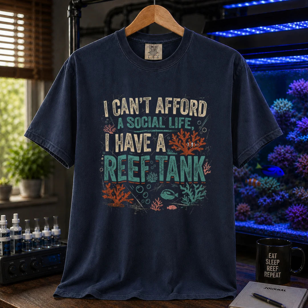 Saltwater aquarium graphic t-shirt featuring a vintage square design with text reading I Can't Afford a Social Life, I Have a Reef Tank and coral illustrations, navy crew neck tee