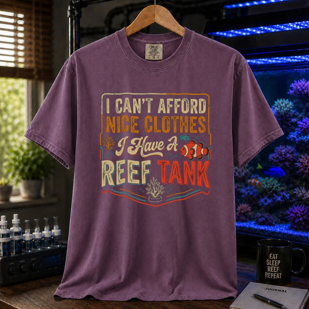 Saltwater aquarium graphic t-shirt featuring a vintage square design with text reading I Can't Afford Nice Clothes, I Have a Reef Tank and a clownfish illustration, purple crew neck tee