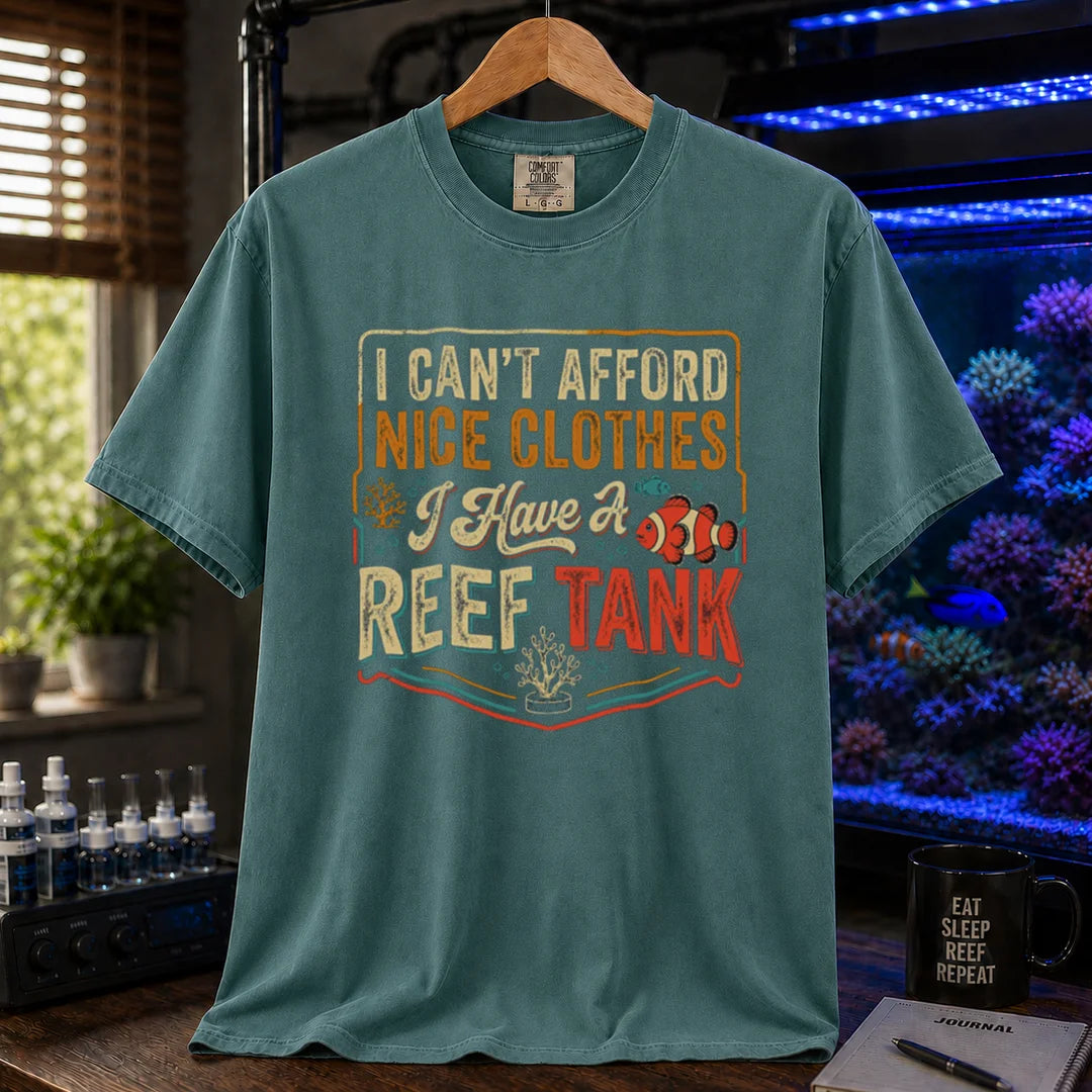 Saltwater aquarium graphic t-shirt featuring a vintage square design with text reading I Can't Afford Nice Clothes, I Have a Reef Tank and a clownfish illustration, green crew neck tee