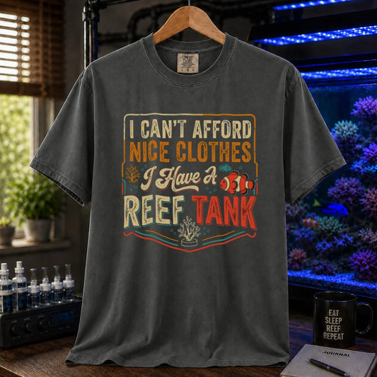 Saltwater aquarium graphic t-shirt featuring a vintage square design with text reading I Can't Afford Nice Clothes, I Have a Reef Tank and a clownfish illustration, dark grey crew neck tee