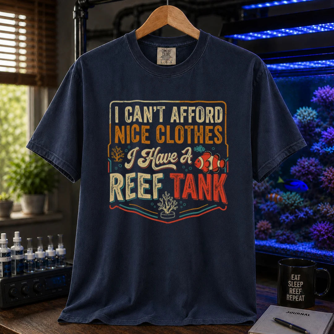Saltwater aquarium graphic t-shirt featuring a vintage square design with text reading I Can't Afford Nice Clothes, I Have a Reef Tank and a clownfish illustration, navy crew neck tee