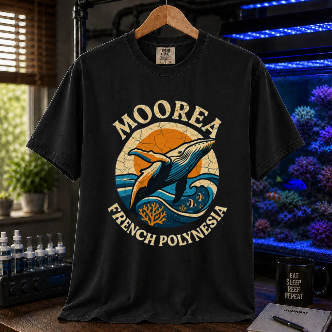 Saltwater aquarium graphic t-shirt featuring a retro circular emblem with a breaching whale and coral, arched text reading Moorea French Polynesia, black crew neck tee