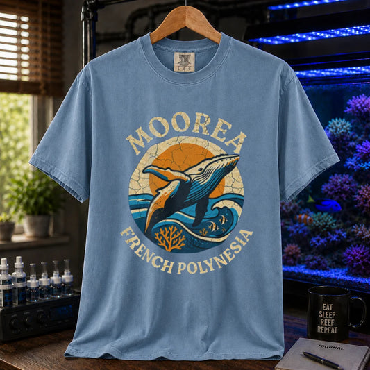 Saltwater aquarium graphic t-shirt featuring a retro circular emblem with a breaching whale and coral, arched text reading Moorea French Polynesia, blue crew neck tee