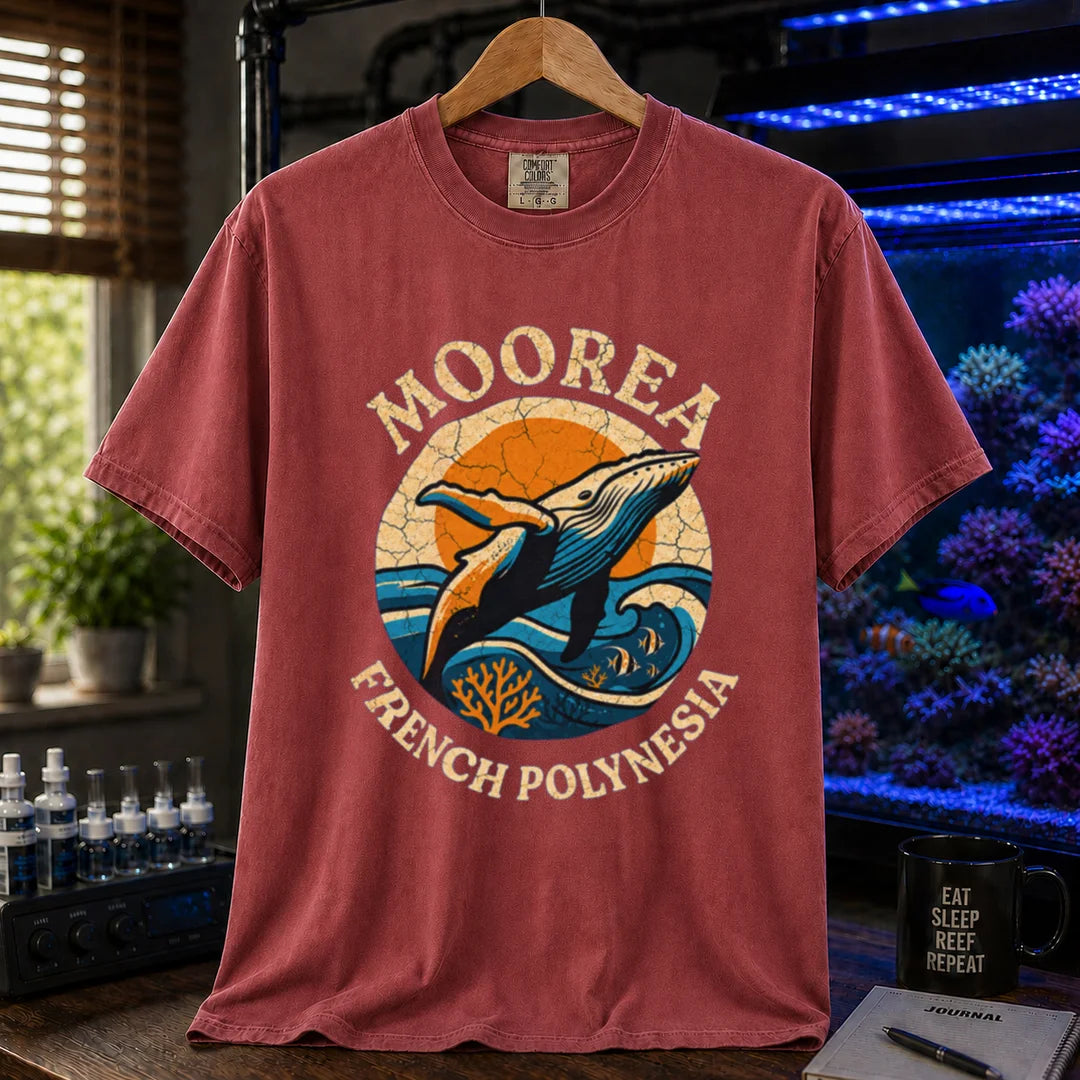 Saltwater aquarium graphic t-shirt featuring a retro circular emblem with a breaching whale and coral, arched text reading Moorea French Polynesia, maroon, red crew neck tee