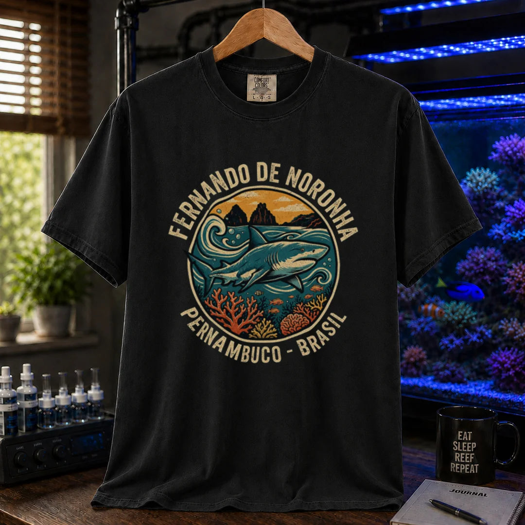 Saltwater aquarium graphic t-shirt featuring a retro circular emblem with a shark and coral, arched text reading Fernando de Noronha Pernambuco Brasil, black crew neck tee