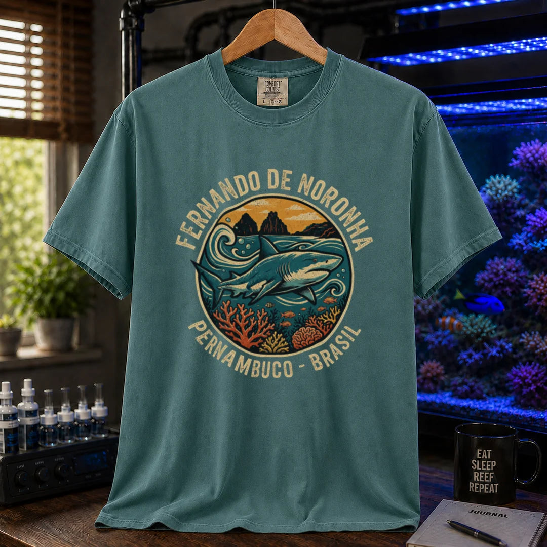 Saltwater aquarium graphic t-shirt featuring a retro circular emblem with a shark and coral, arched text reading Fernando de Noronha Pernambuco Brasil, green crew neck tee