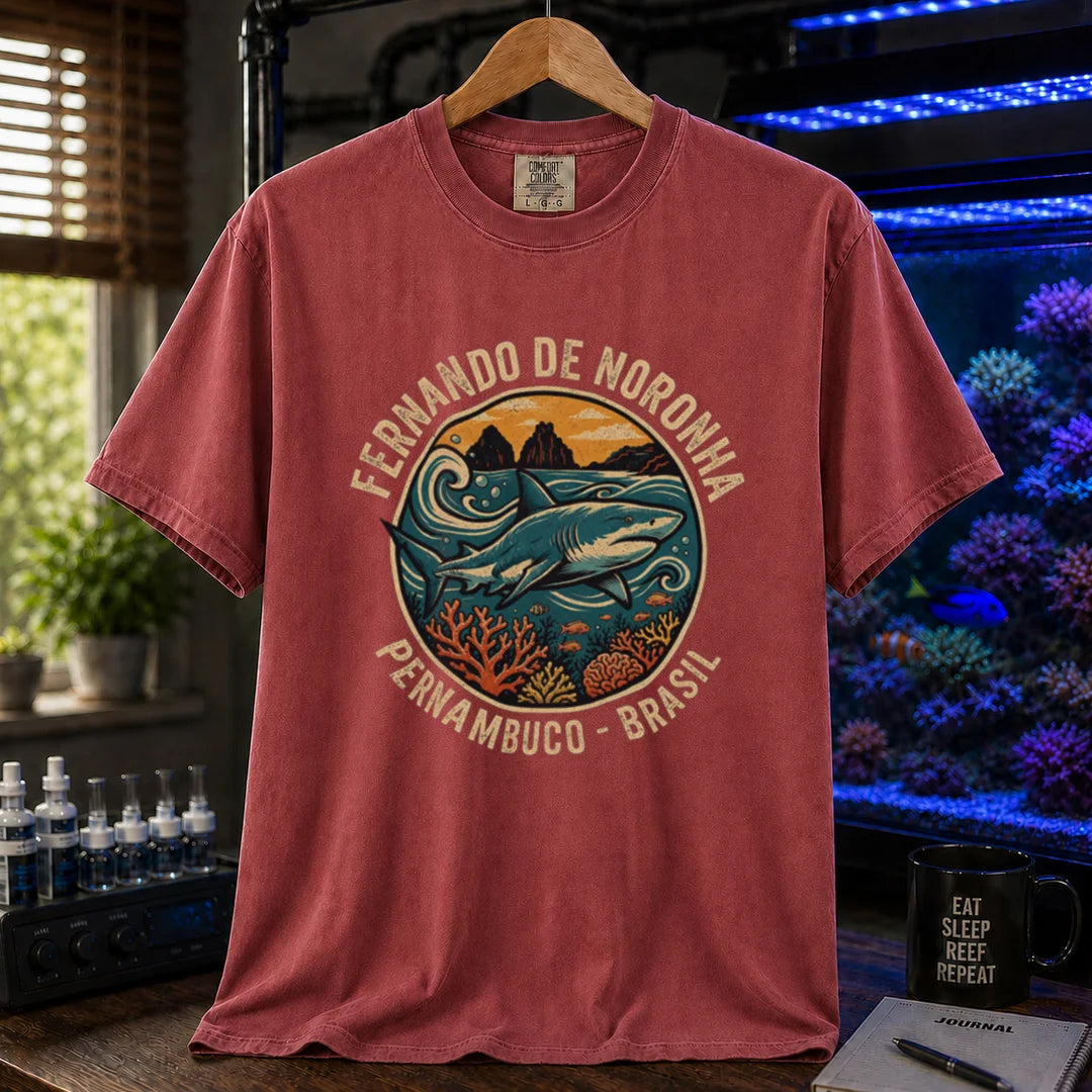 Saltwater aquarium graphic t-shirt featuring a retro circular emblem with a shark and coral, arched text reading Fernando de Noronha Pernambuco Brasil, maroon, red crew neck tee