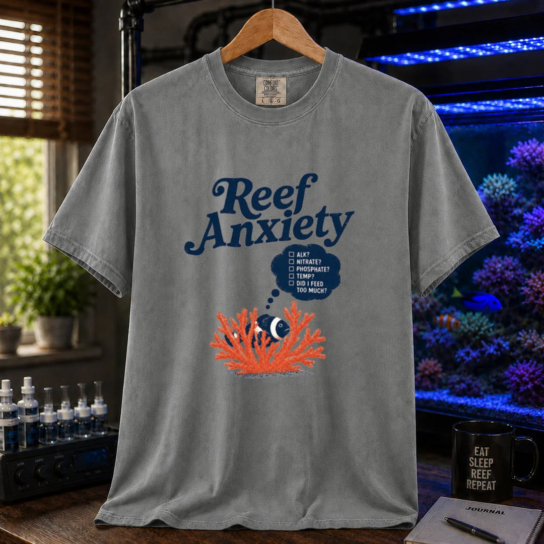Saltwater aquarium graphic t-shirt featuring blue text reading Reef Anxiety and an illustration of a clownfish in coral with a thought bubble checklist, grey crew neck tee