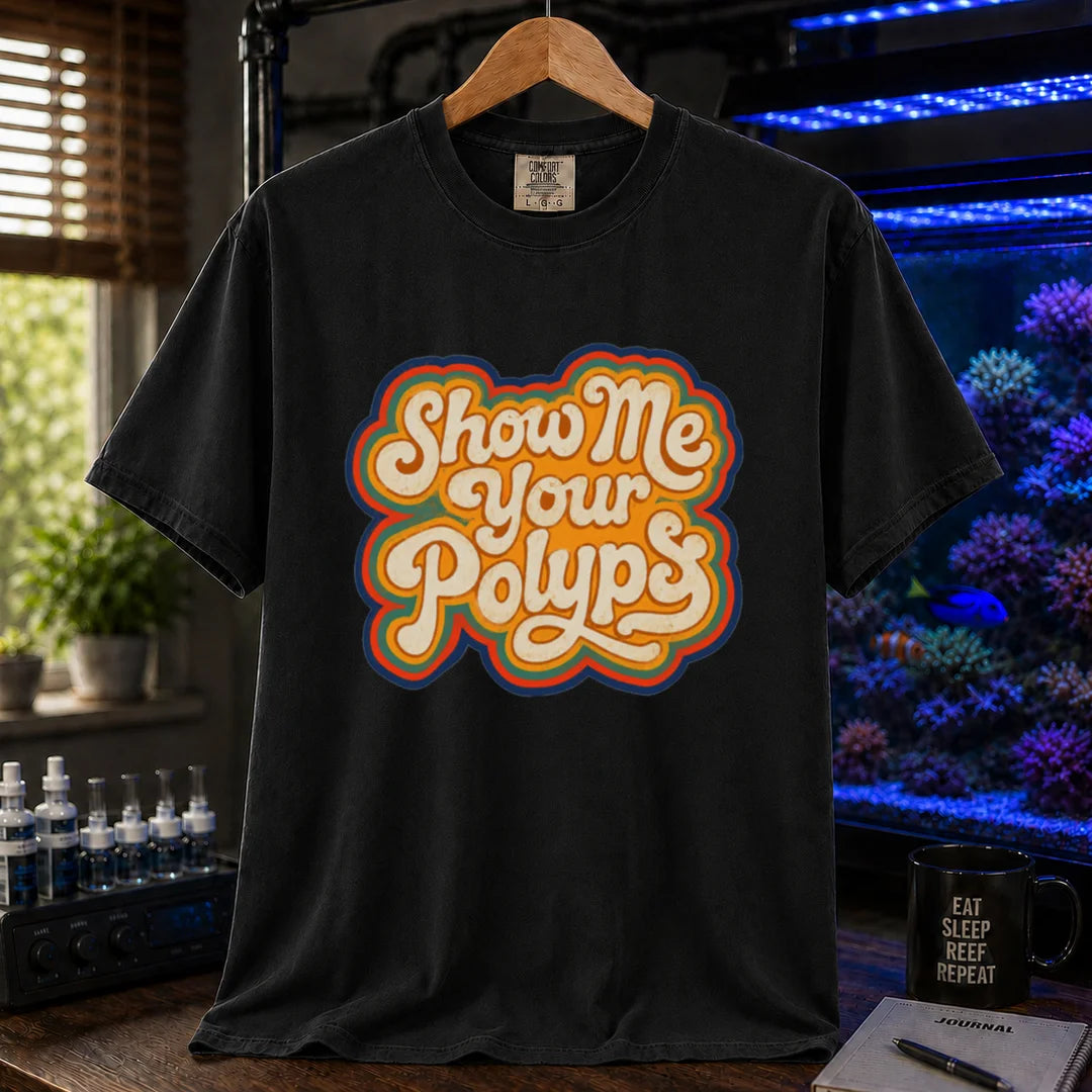 Saltwater aquarium graphic t-shirt featuring retro multi-layered stacked typography in cream, yellow, and orange reading Show Me Your Polyps, black crew neck tee