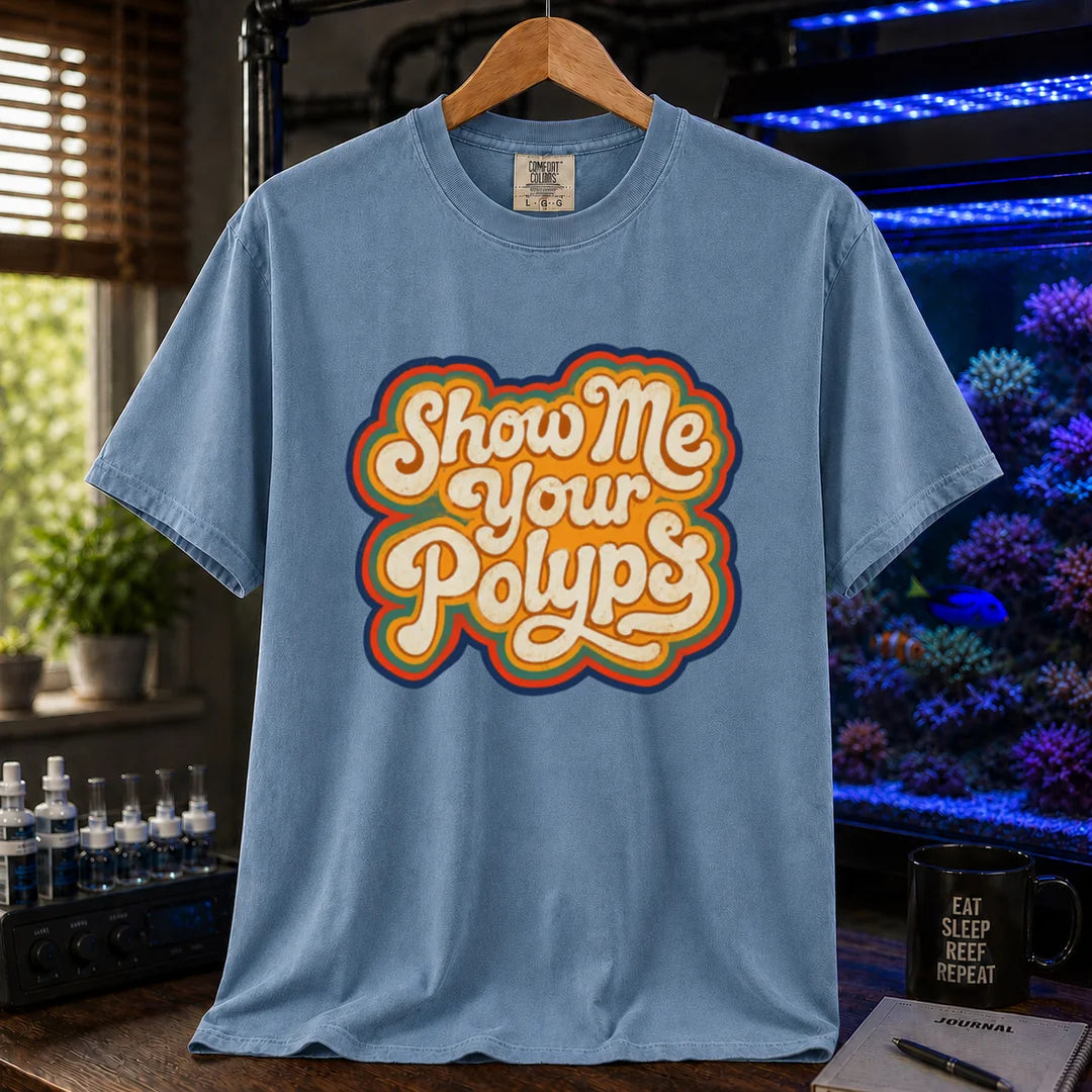 Saltwater aquarium graphic t-shirt featuring retro multi-layered stacked typography in cream, yellow, and orange reading Show Me Your Polyps, blue crew neck tee
