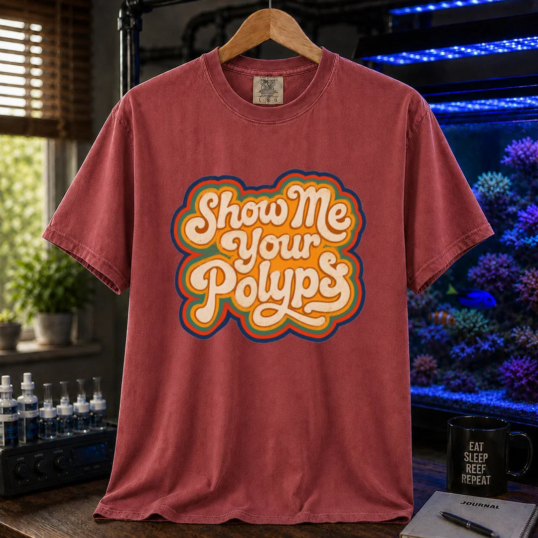 Saltwater aquarium graphic t-shirt featuring retro multi-layered stacked typography in cream, yellow, and orange reading Show Me Your Polyps, maroon, red crew neck tee