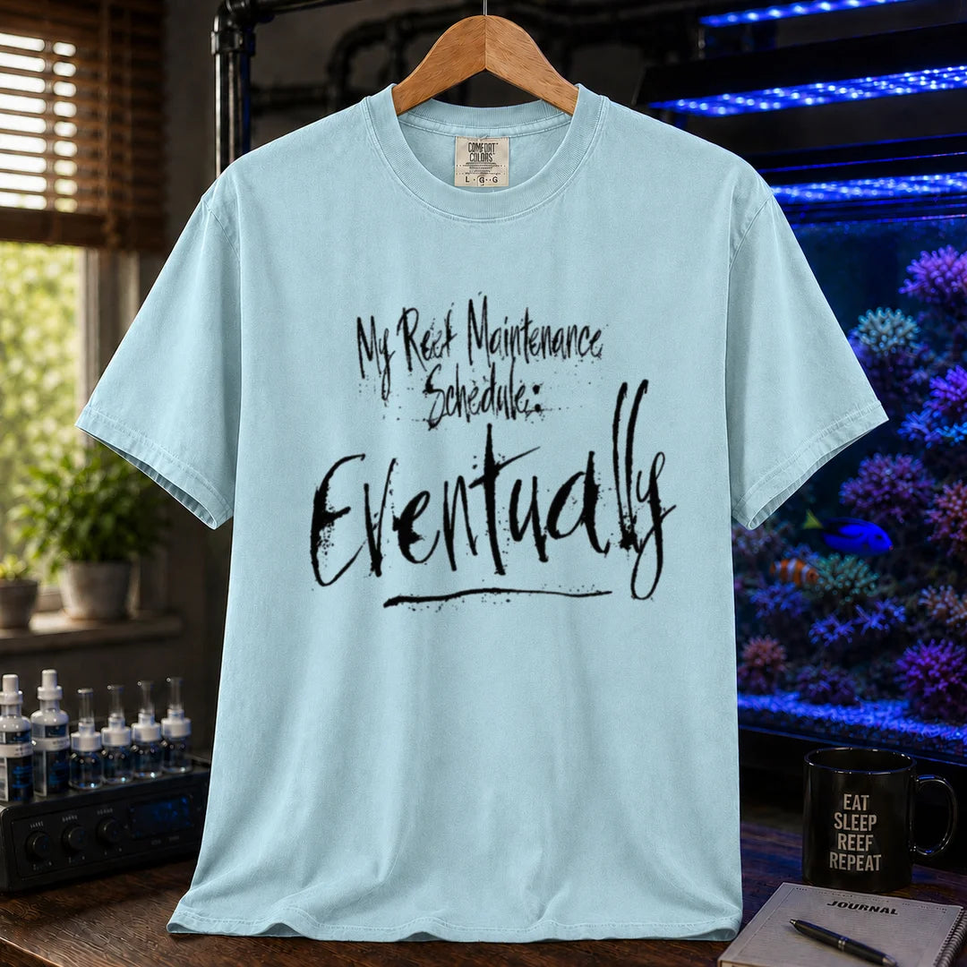 Saltwater aquarium graphic t-shirt featuring grunge brushstroke typography reading My Reef Maintenance Schedule: Eventually, light blue crew neck tee
