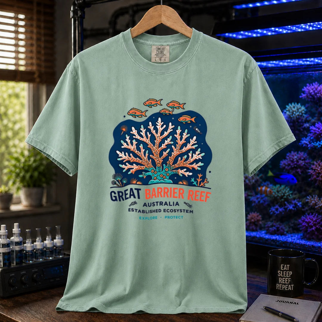 Saltwater aquarium graphic t-shirt featuring an illustration of a coral colony and fish with text reading Great Barrier Reef Australia Established Ecosystem Explore Protect, green crew neck tee