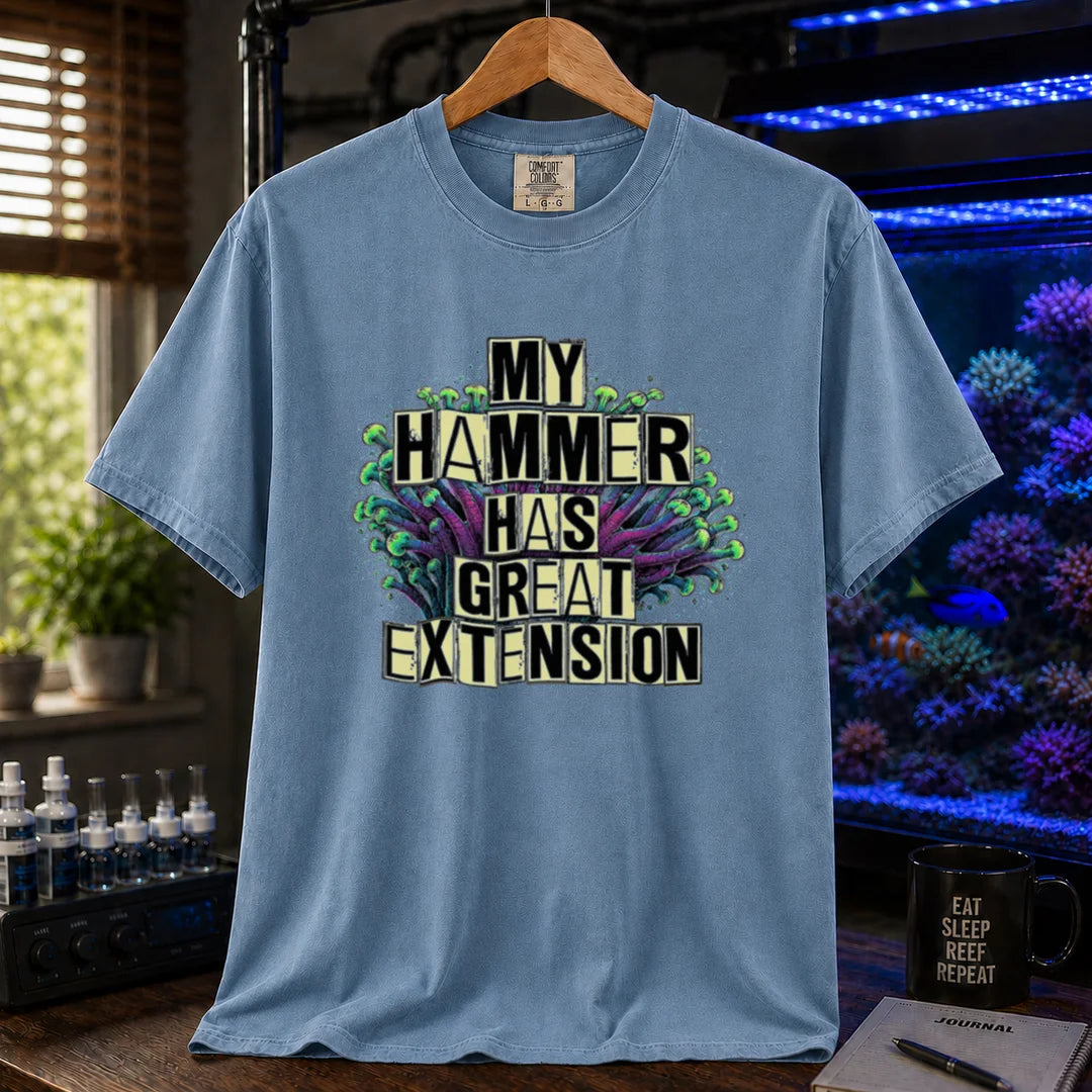Saltwater aquarium graphic t-shirt featuring bold block text reading My Hammer Has Great Extension layered over a hammer coral illustration, blue crew neck tee