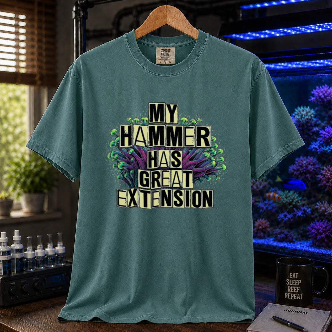 Saltwater aquarium graphic t-shirt featuring bold block text reading My Hammer Has Great Extension layered over a hammer coral illustration, green crew neck tee