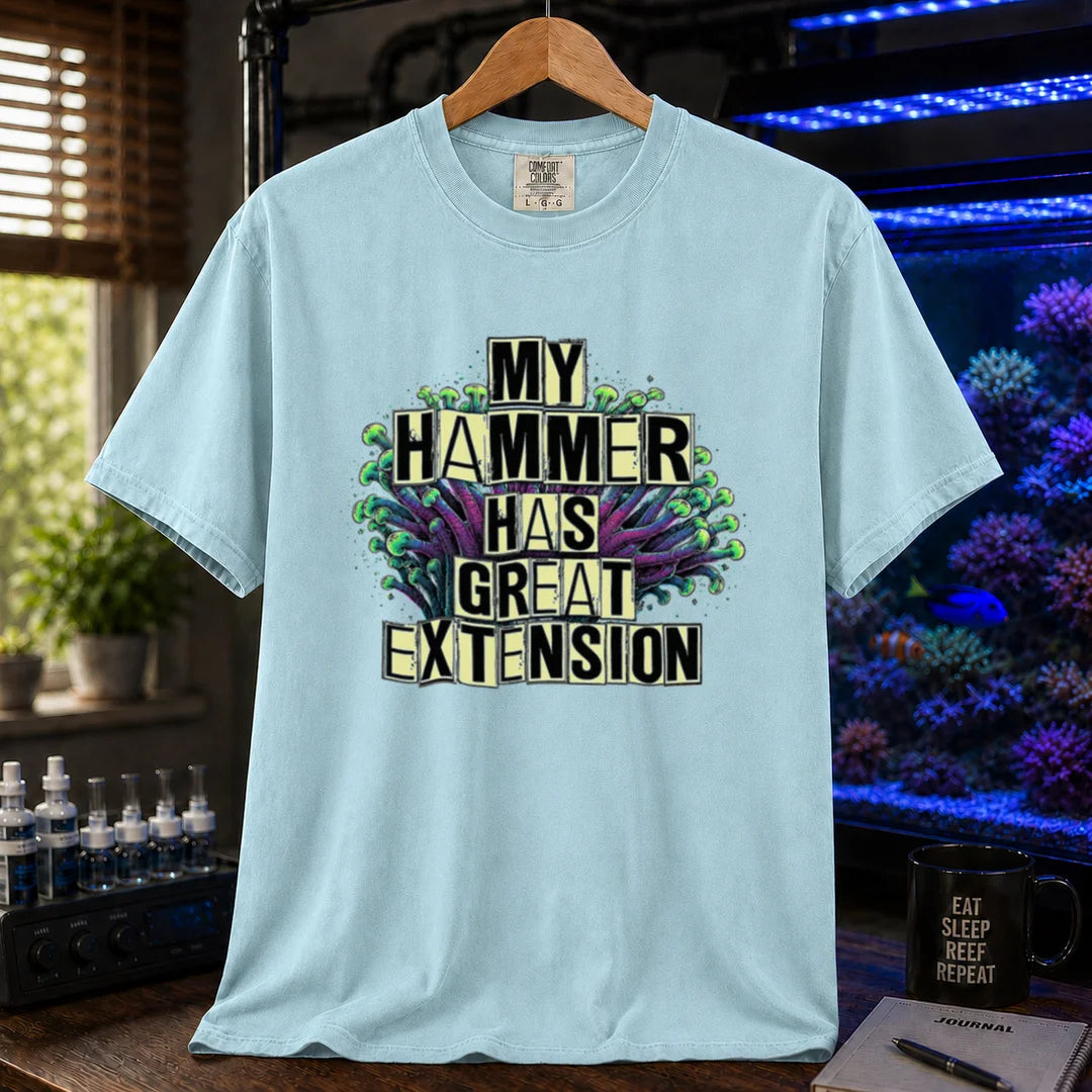 Saltwater aquarium graphic t-shirt featuring bold block text reading My Hammer Has Great Extension layered over a hammer coral illustration, light blue crew neck tee