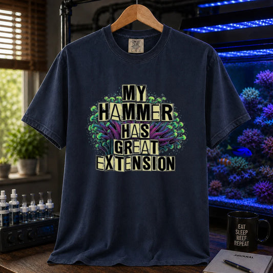 Saltwater aquarium graphic t-shirt featuring bold block text reading My Hammer Has Great Extension layered over a hammer coral illustration, navy crew neck tee