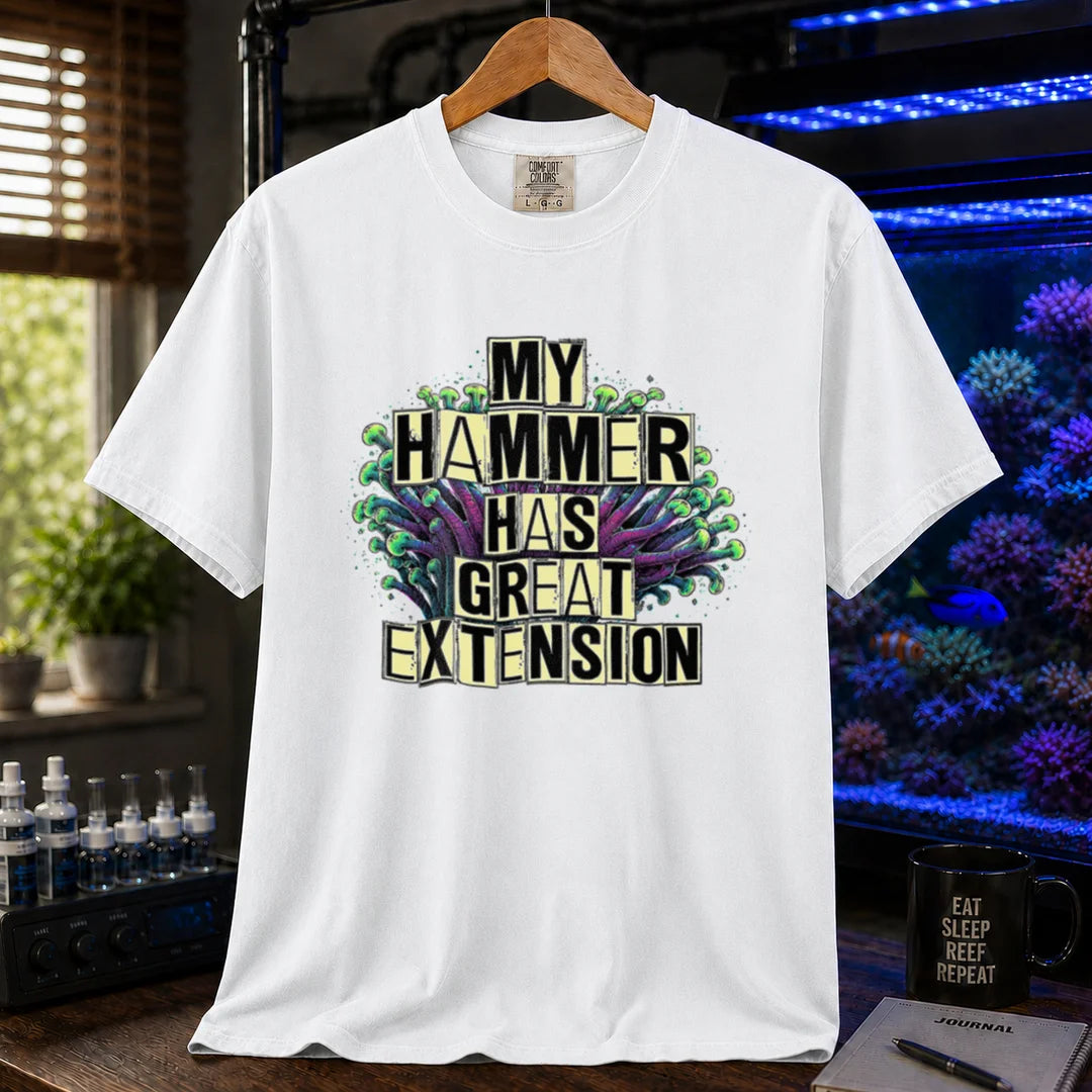 Saltwater aquarium graphic t-shirt featuring bold block text reading My Hammer Has Great Extension layered over a hammer coral illustration, white crew neck tee