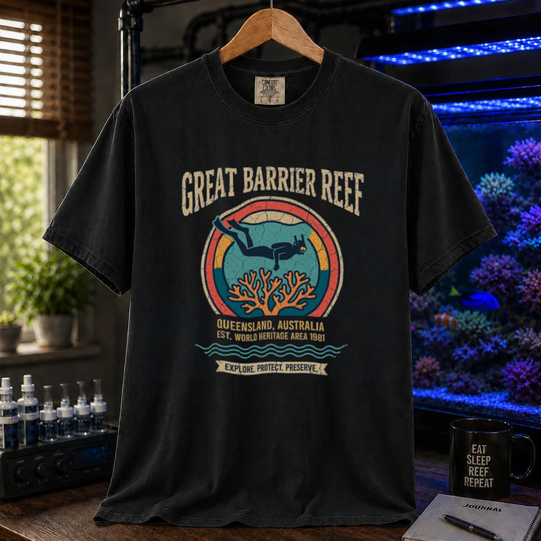 Saltwater aquarium graphic t-shirt featuring a retro circular emblem with a scuba diver and coral, arched text reading Great Barrier Reef Queensland Australia Est World Heritage Area 1981, black crew neck tee