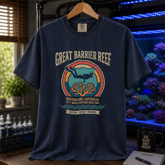 Saltwater aquarium graphic t-shirt featuring a retro circular emblem with a scuba diver and coral, arched text reading Great Barrier Reef Queensland Australia Est World Heritage Area 1981, navy crew neck tee