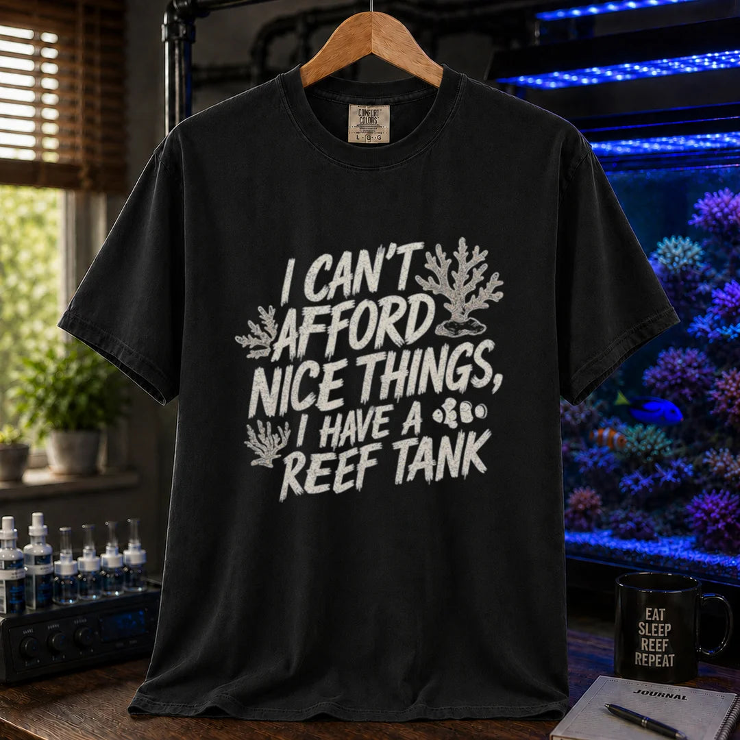 Saltwater aquarium graphic t-shirt featuring distressed white typography reading I Can't Afford Nice Things, I Have A Reef Tank with coral and clownfish illustrations, black crew neck tee