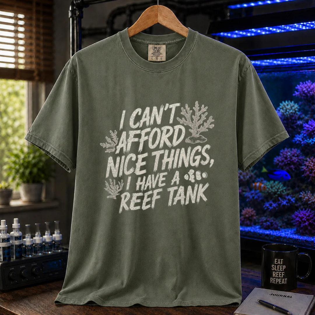 Saltwater aquarium graphic t-shirt featuring distressed white typography reading I Can't Afford Nice Things, I Have A Reef Tank with coral and clownfish illustrations, military green crew neck tee