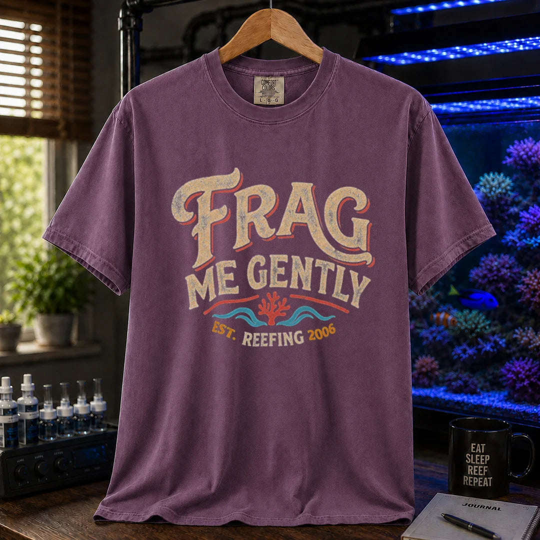 Saltwater aquarium graphic t-shirt featuring distressed vintage cream typography reading Frag Me Gently with coral graphics and Est. Reefing 2006, purple crew neck tee