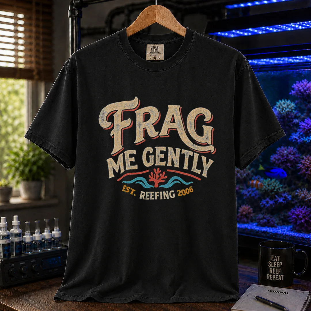 Saltwater aquarium graphic t-shirt featuring distressed vintage cream typography reading Frag Me Gently with coral graphics and Est. Reefing 2006, black crew neck tee