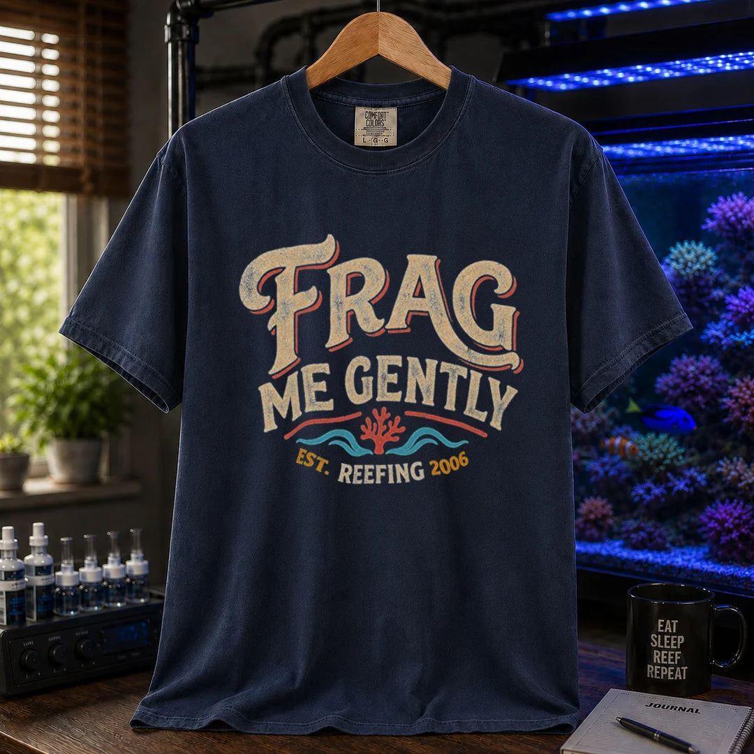 Saltwater aquarium graphic t-shirt featuring distressed vintage cream typography reading Frag Me Gently with coral graphics and Est. Reefing 2006, navy crew neck tee