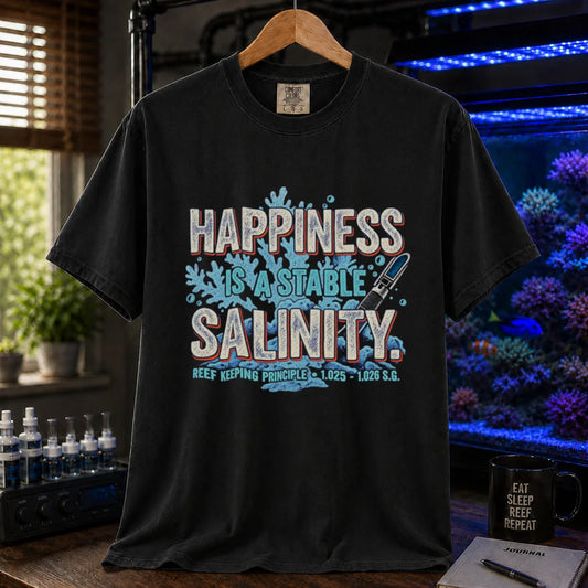 Saltwater aquarium graphic t-shirt featuring distressed retro typography reading Happiness Is A Stable Salinity with coral and refractometer illustrations, black crew neck tee