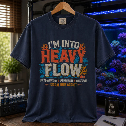 Saltwater aquarium graphic t-shirt featuring distressed retro typography reading I'm Into Heavy Flow with coral and fish illustrations and footer text, navy crew neck tee