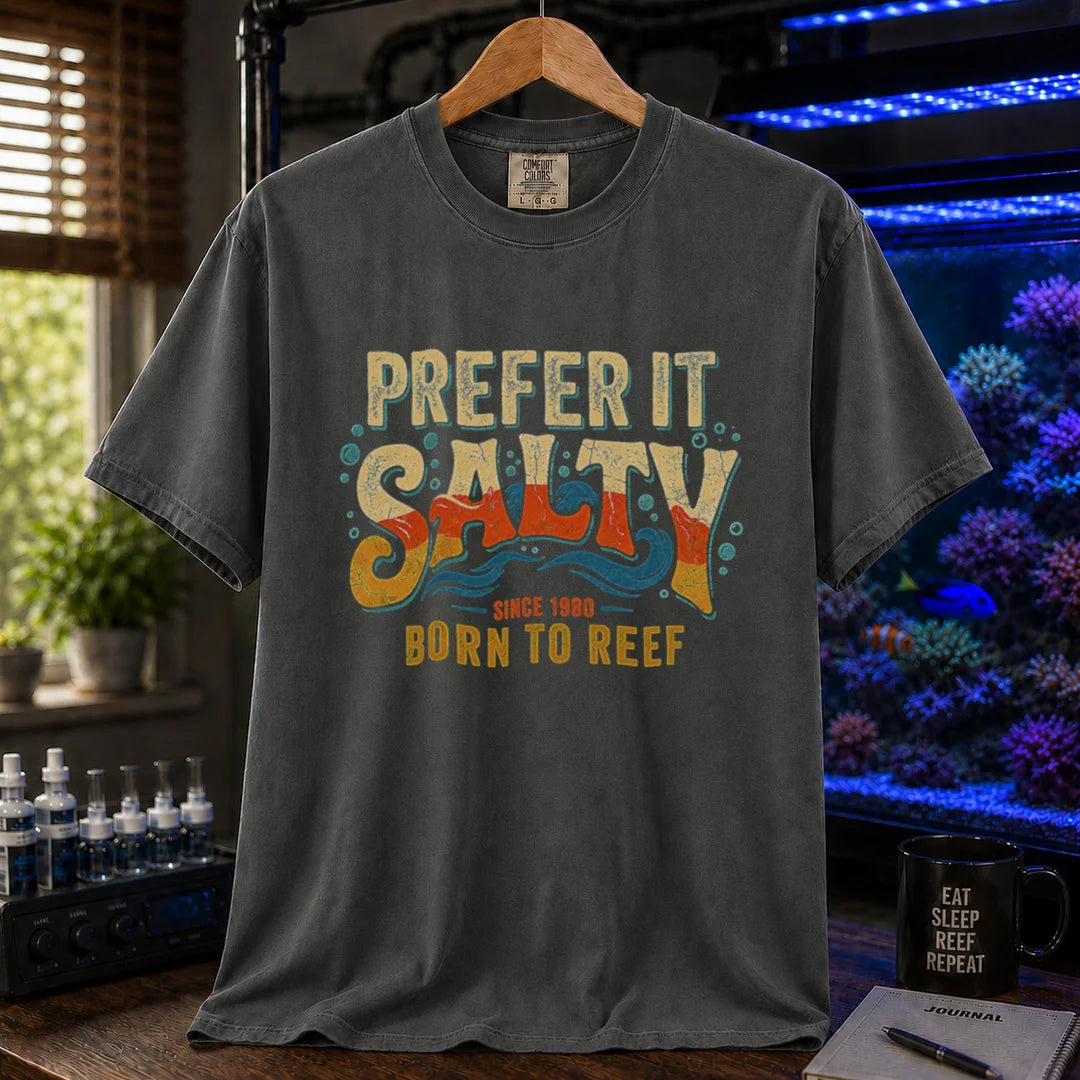 Saltwater aquarium graphic t-shirt featuring distressed retro typography in yellow, orange, and teal reading Prefer It Salty Born To Reef Since 1980 with wave graphics,dark grey crew neck tee